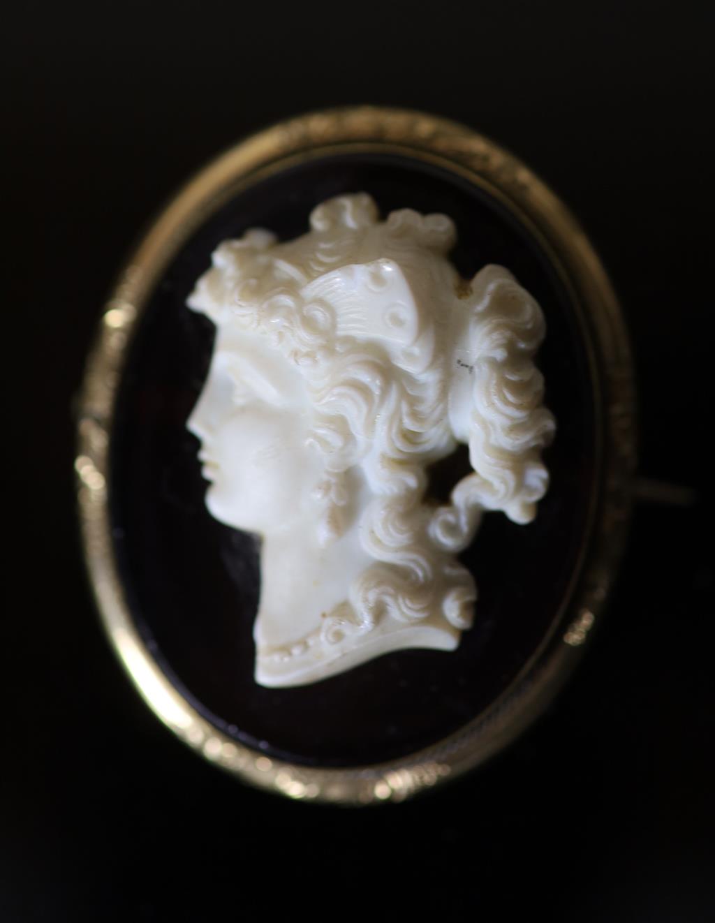 A Victorian gilt metal mounted composition glass? oval cameo brooch, carved with bust of a lady to dexter, 45mm.